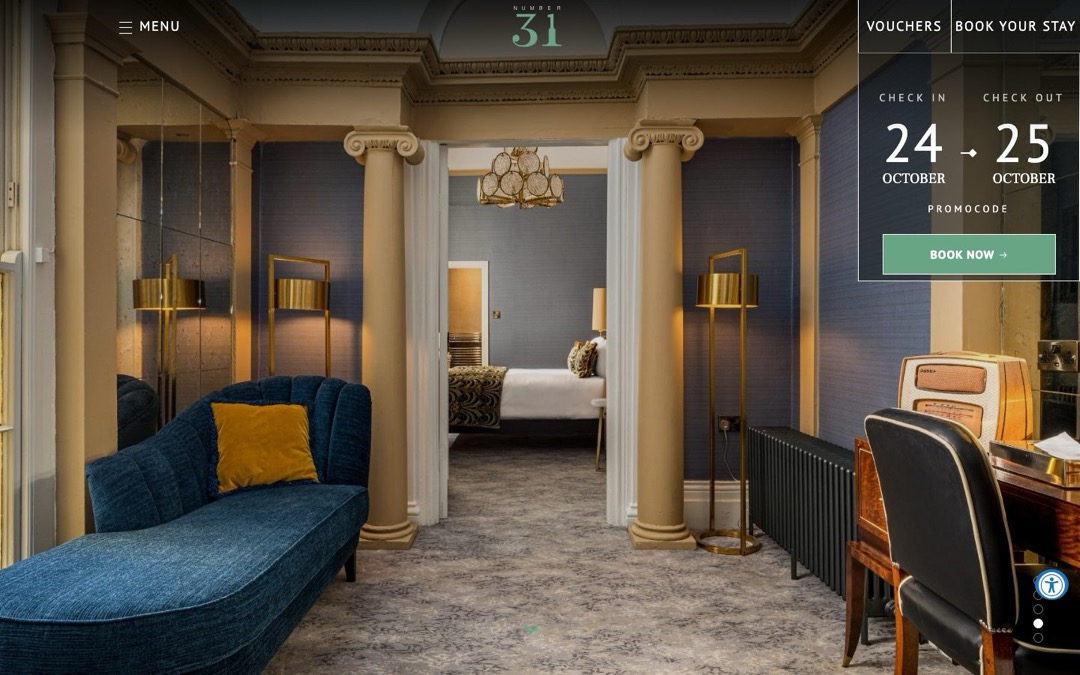 Opening photo of the Number 31 website: a guest room with a gold velvet headboard and a teal bedspread