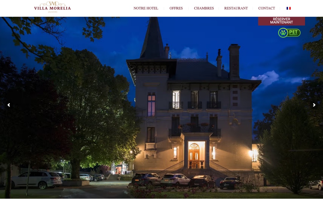 Accueil du site de la Villa Morelia : photo de nuit de la villa éclairée et bouton rouge « Réserver maintenant » fixé à l’écran